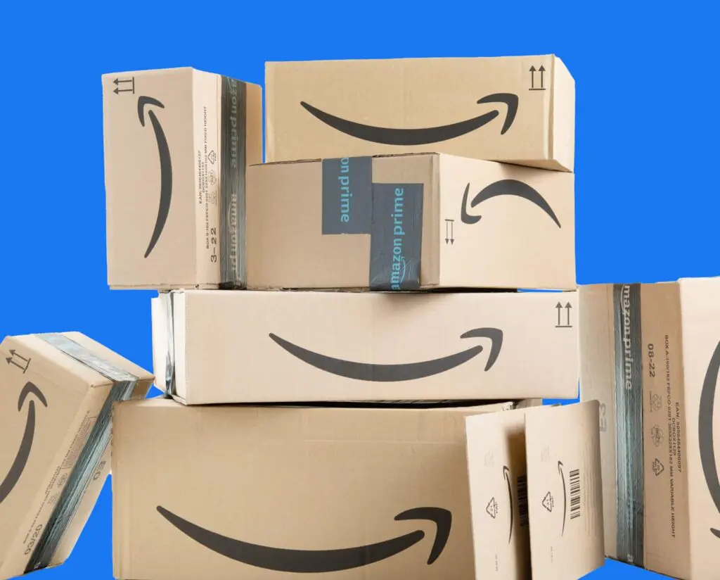 A stack of Amazon packages and other packages on their sides with blue background