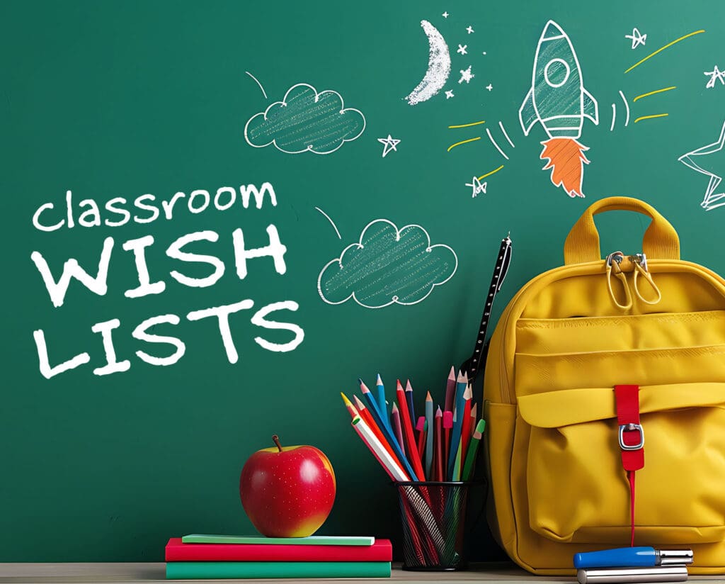 Classroom whiteboard with the words "classroom wish lists" written on it in chalk with yellow backpack